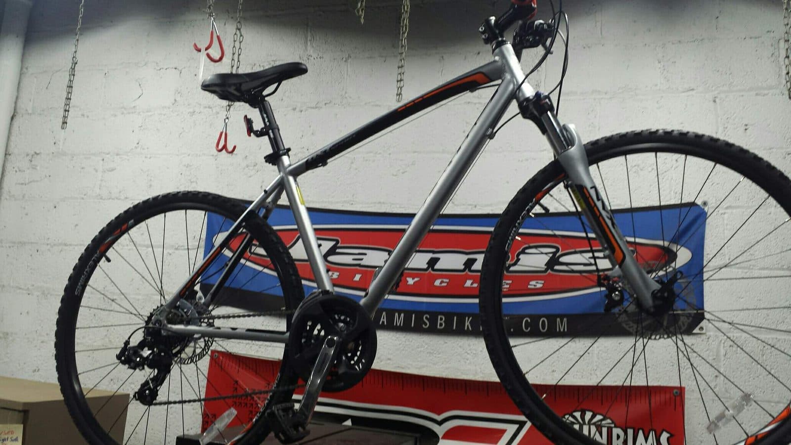 Inside Beeton's Cyclery — a Jamis bike hanging in the repair area of the shop